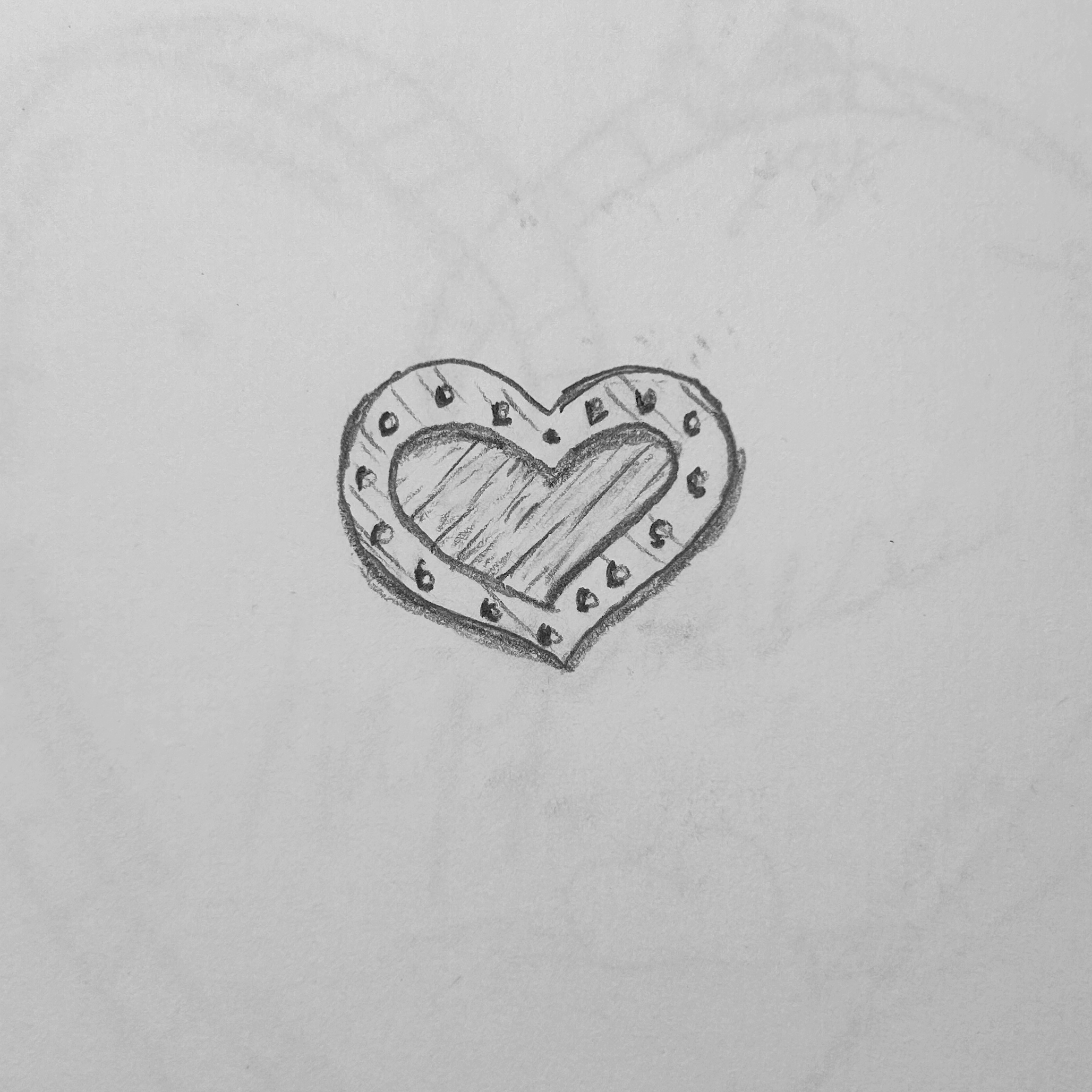 Armored, riveted heart with a softer heart inside