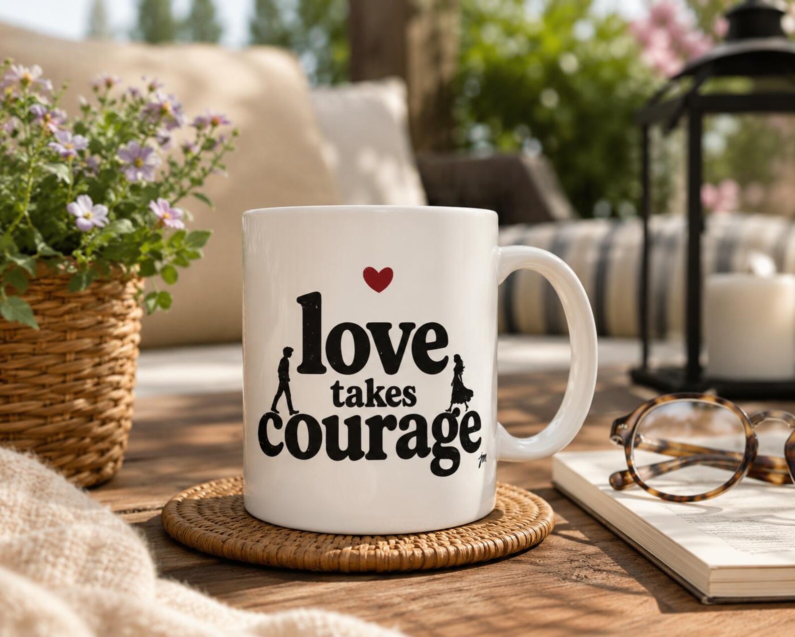 Love Takes Courage ceramic mug with a small red heart on a cozy table